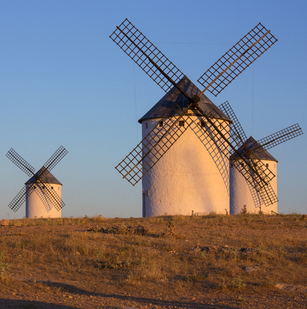 Late afternoon sunlight on the windmills of Campo de Criptana in the La Mancha region of central Spain の写真素材