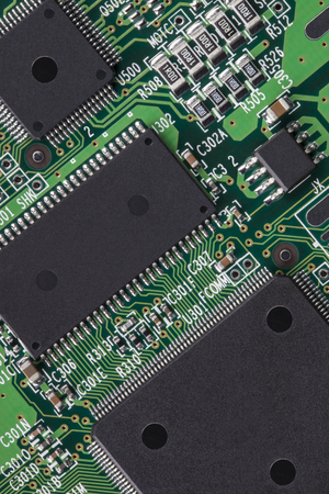Close-up of a computer printed circuit board showing the complex connections between microprocessor 