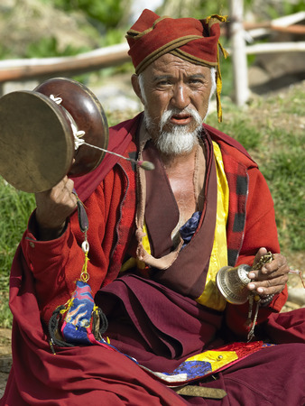 A Bhutanese man with prayer drum at Paro market in the Kingdom of Bhutan.のeditorial素材