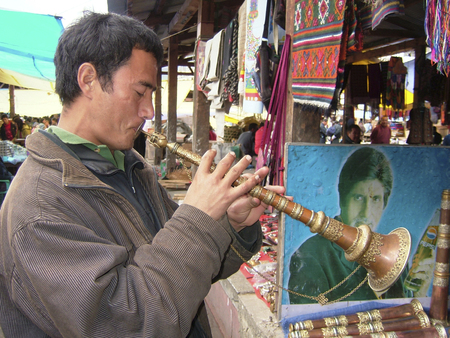 A Bhutanese man playing a Tibetan Horn on a market in Paro in the Kingdom of Bhutanのeditorial素材