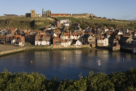 Ruins of Whitby Abbey above the town and harbor of Whitby on the North Yorkshire coast in northern England. のeditorial素材