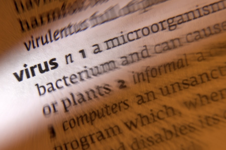 Virus - 1. infective agent that consists of a nucleic acid molecule in a protein coat that is able to multiply only within the living cells of a host. 2. a piece of computer code that can corrupt a system or destroy data.の写真素材