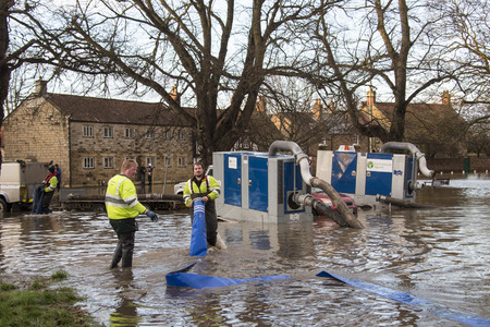Environment Agency workers using high pressure pumps to drain flooding after the River Derwent burst its banks - Malton - UNited Kingdomのeditorial素材