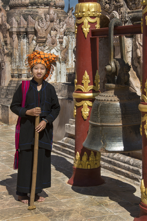 A woman of the PaO people ringing a temple bell in the Kakku Buddhist Temple in Shan State in Myanmar - Burma  のeditorial素材