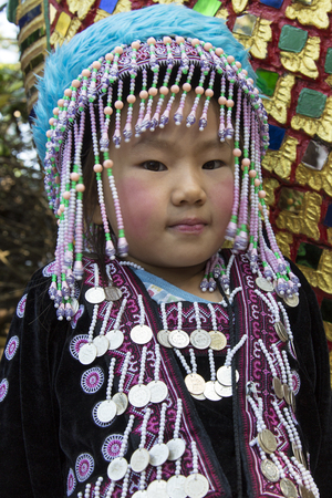 A young child in traditional dress at Doi Suthep Buddhist temple near Chiang Mai in northern Thailand のeditorial素材