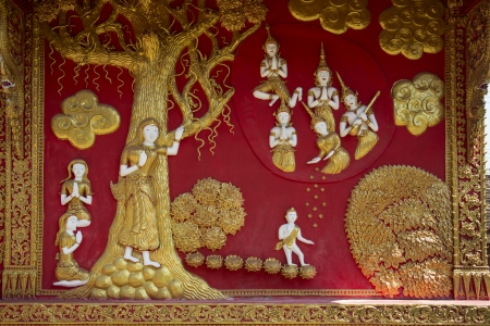 Decorative bass relief on a temple exterior at Wat Phra That Lampang Luang temple complex near Lampang in northern Thailand のeditorial素材