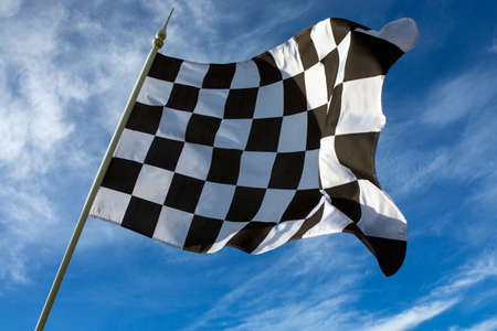 Chequered Flag - Winner - The chequered flag is used to end a motor race  The flag is commonly associated with the winner of a race, as they are the first driver to  take   drive past  the chequered flag の写真素材