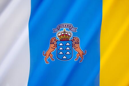 The flag of the Autonomous Community of the Canary Islands - The tricolour flag has its origins in the Canarias Libre movement of the 1960s.の写真素材