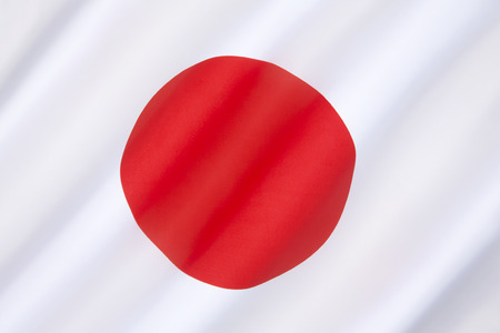 The national flag of Japan - a white rectangular flag with a large red disc (representing the sun) in the center. This flag is officially called Nisshoki in Japanese, but is more commonly known as Hinomaru.の写真素材