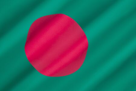 Flag of Bangladesh - The red disc, representing the sun, is off set from center on a green background representing the lush green land of Bangladesh. Adopted on 17th January 1972.の写真素材