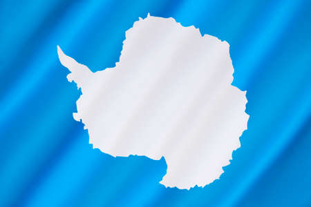 Antarctica has no official flag as it is not a nation nor is it ruled by a single government. This is the most widly used flag - a plain white map of the continent on a blue background symbolizes neutrality. The flag was flown on the Antarctic continent fの写真素材