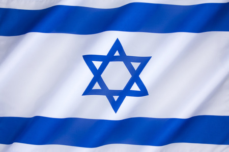 The flag of Israel was adopted on October 28, 1948, five months after the establishment of the State of Israel. The symbol in the centre represents the Star of David.の写真素材