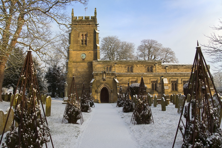 Winter snow in the graveyard of an English Parish Church in the small village of Slingsby in North Yorkshire in northern England.のeditorial素材