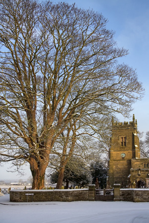 Winter snow and an English Parish Church in the small village of Slingsby in North Yorkshire in northern England.のeditorial素材