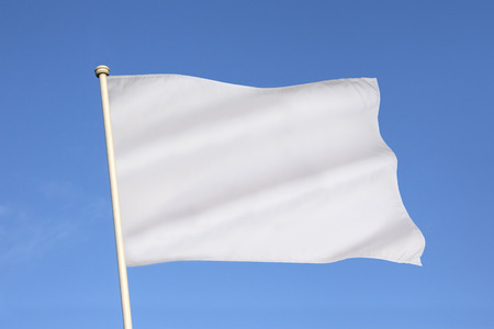 The white flag is an internationally recognized symbol of surrender, truce, or a desire to parley.の写真素材