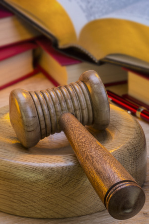 A gavel is a small ceremonial mallet which an auctioneer, a judge, or the chair of a meeting hits a surface to call for attention or order.の写真素材
