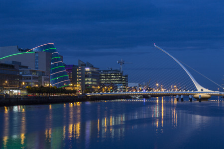 The River Liffey, the Samuel Beckett Bridge and the building on the waterfront near the Convention Center - Dublin city center in the republic of Ireland.のeditorial素材