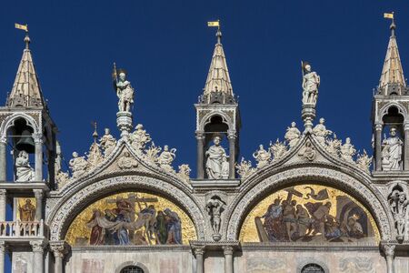Sunshine glinting off the mosaic panals on St Mark's Basilica in Venice in northern Italy.
