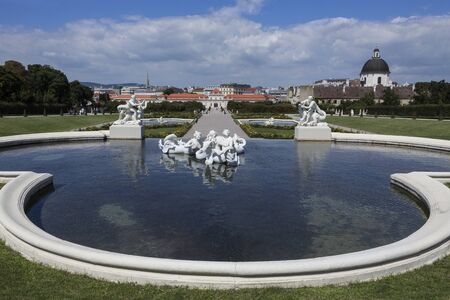 Statues and fountains of Lower Belverdere Palace in Vienna - Austria. The Belvedere is a historic building complex consisting of two Baroque palaces (the Upper and Lower Belvedere), the Orangery, and the Palace Stables. It was built as a summer residence のeditorial素材