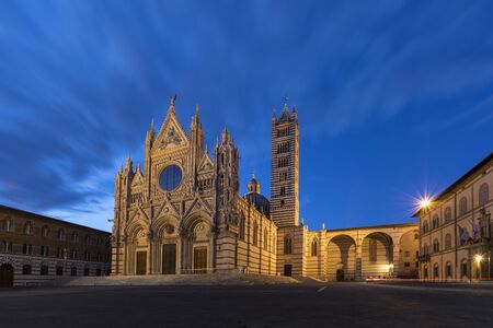 Siena - Italy. The 12th century Siena Cathedral (The Duomo) at dusk. A masterpiece of Italian Romanesque-Gothic architecture.の写真素材