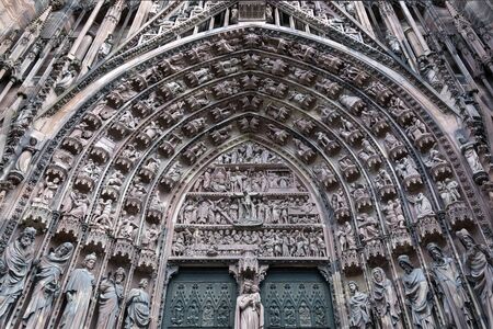 Detail of the fine sculpture above the main doors on the west facade of Strasbourg Cathedral in the...