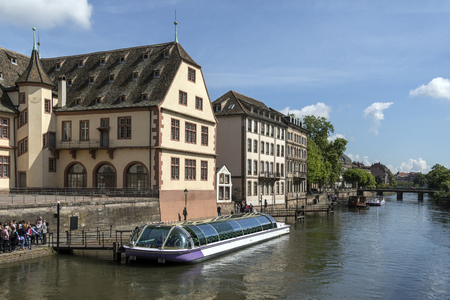 Tourist boat and old buildings in the historic city of Strasbourg in the Alsace region of France.のeditorial素材
