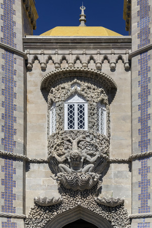 Fine 17th century sculpture of mythological triton, symbolizing the creation of the world. Above the main entrance door in the Pena National Palace at Sintra near Lisbon in Portugal.のeditorial素材