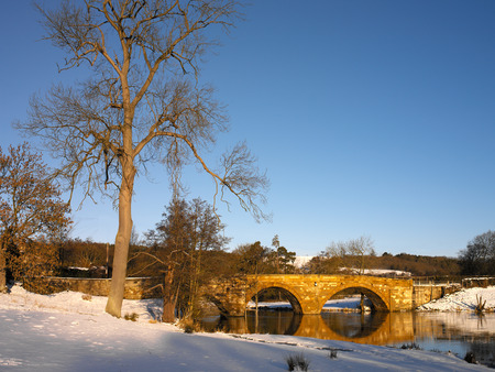 Rural Winter scene of a bridge over the River Derwent in North Yorkshire near the market town of...