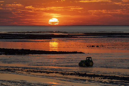 Sunset at low tide over the beach at Chatelaillon Plage near La Rochelle in the Charente-Maritime department of southwest France.の写真素材