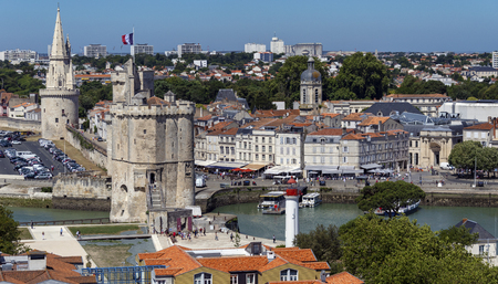 High level view of the port of La Rochelle on the coast of the Poitou-Charentes region of France. The tower with the flag is the Tour de la Chaine which dates from the 11th century.のeditorial素材
