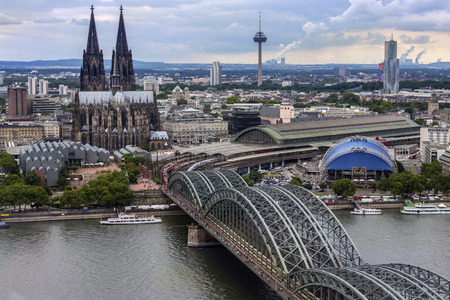 The Hohenzollern Bridge and Cologne Cathedral in the industrial and university city of Cologne situated on the River Rhine in Germany.のeditorial素材