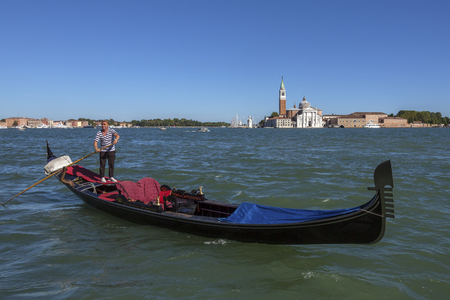 Gondola and the Benedictine church on the Island of San Giorgio Maggiorea in the Venetian Lagoon, Venice, Italy.のeditorial素材
