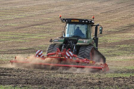 Malton. England. 09.22.19. Tractor pulling a Ridged Roller (UK) or  Cultipacker (USA) on a field in...