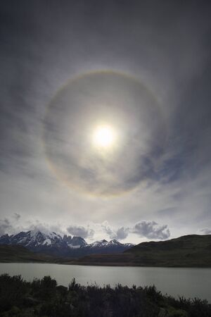 Ring around the sun - caused by ice crystals within thin cirrus clouds. The refraction causes light to shine into a ring. Torres Del Paine National Park in Patagonia, Chile, South America.の写真素材