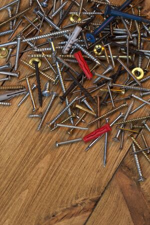 Screws and Nails on a wooden backgroundの写真素材