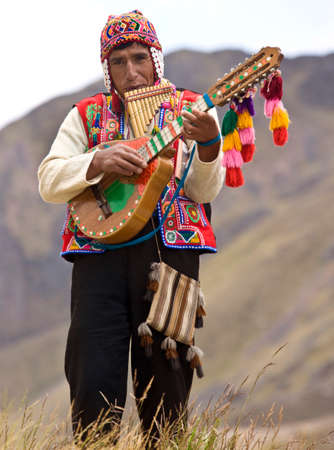 Peru. 04.23.08. Peruvian man playing pan pipes and banjo - Valley of the Incas in Peru, South America.のeditorial素材