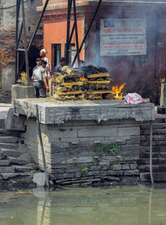 Kathmandu. Nepal. 03.16.05. Cremation on the Ghats by the Bagmati River in Pashupatinath Hindu Temple in Kathmandu, Nepal. UNESCO World Heritage Site.のeditorial素材