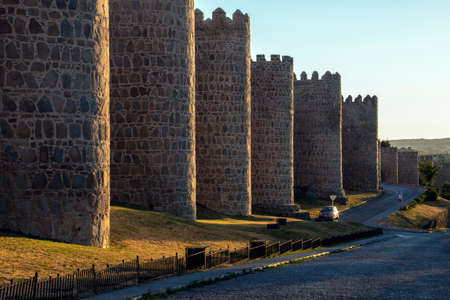 Late afternoon sunlight on the medieval city walls around the city of Avila in the Castila-y-Leon region of central Spain.の素材 [FY310163913839]