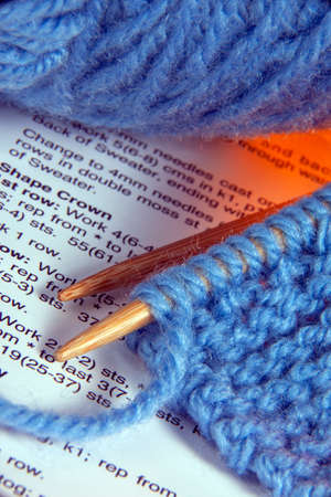 Knitting - a method by which yarn or wool is manipulated to create a textile or fabric; it is used in many types of garments. Knitting may be done by hand or by machine.の写真素材