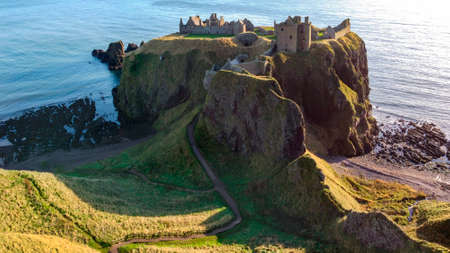 Dunnottar Castle - a ruined medieval fortress located on a rocky headland in Aberdeenshire on the northeast coast of Scotland, about 2 miles south of Stonehaven. The surviving buildings are largely of the 15th and 16th centuries, but the site is believed to have been fortified in the early Middle Ages.の写真素材