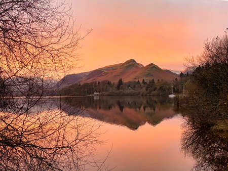 Dawn sunlight in winter at Derwent Water near Keswick in the Lake District in Cumbria, United...