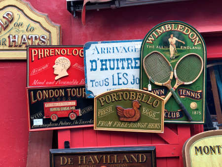Old signs for sale outside a shop in the Portobello Road in London, England.のeditorial素材