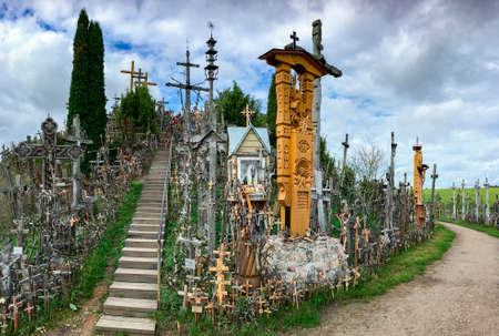 The Hill of Crosses - a site of pilgrimage in northern Lithuania. Over the generations, crosses, crucifixes, statues of the Virgin Mary and thousands of tiny effigies and rosaries have been placed here by Catholic pilgrims.の写真素材