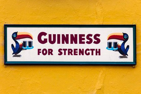 Vintage Guinness advetising sign on a wall outside a pub in Dublin, Republic of Ireland.のeditorial素材