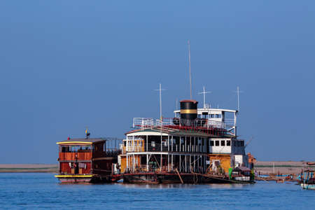 River traffic moored in the Irrawaddy River (Ayeyarwaddy River) in Myanmar (Burma).  It is the country's largest river and most important commercial waterway.の写真素材
