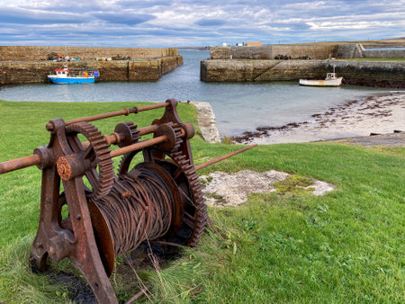 The harbor at Fresgoe near Sandside Beach in Caithness on the north coast of Scotland. Dounreay nuclear plant is visible in the backgroundのeditorial素材