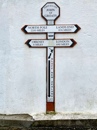 Sign at John Oâ€™Groats in Caithness on the north coast of Scotland.  John o' Groats lies on...