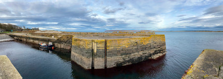 Panoramic view of Castletown harbor with Dunnet Head in the distance. Caithness on the north coast...