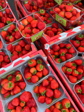 Punnets of fresh strawberries on a market stall.のeditorial素材