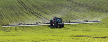 Agriculture - A farmer spraying fertilizer on his crops - North Yorkshire - England.のeditorial素材